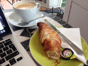 People watching with a latte croissant and marmite